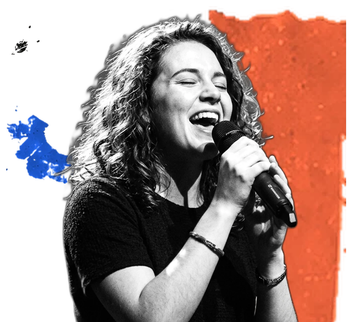 A singer with a microphone over orange and blue paint
