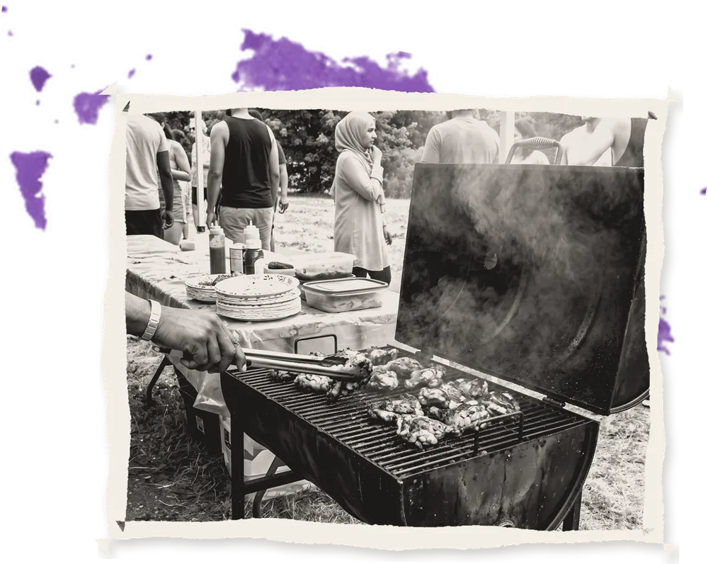 A drum grill smoking at a festival