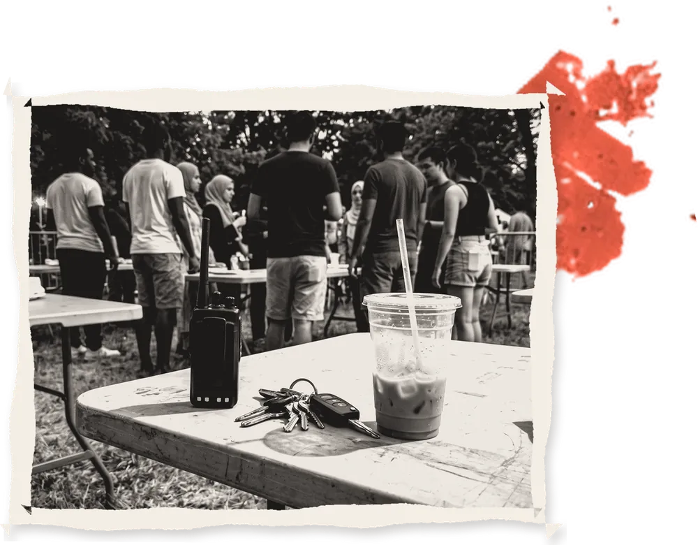 A radio, keys and a drink on a folding table
