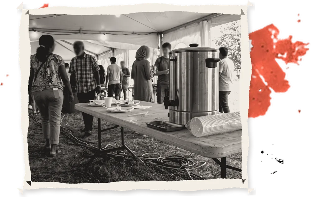 A tea urn and cups under a tent